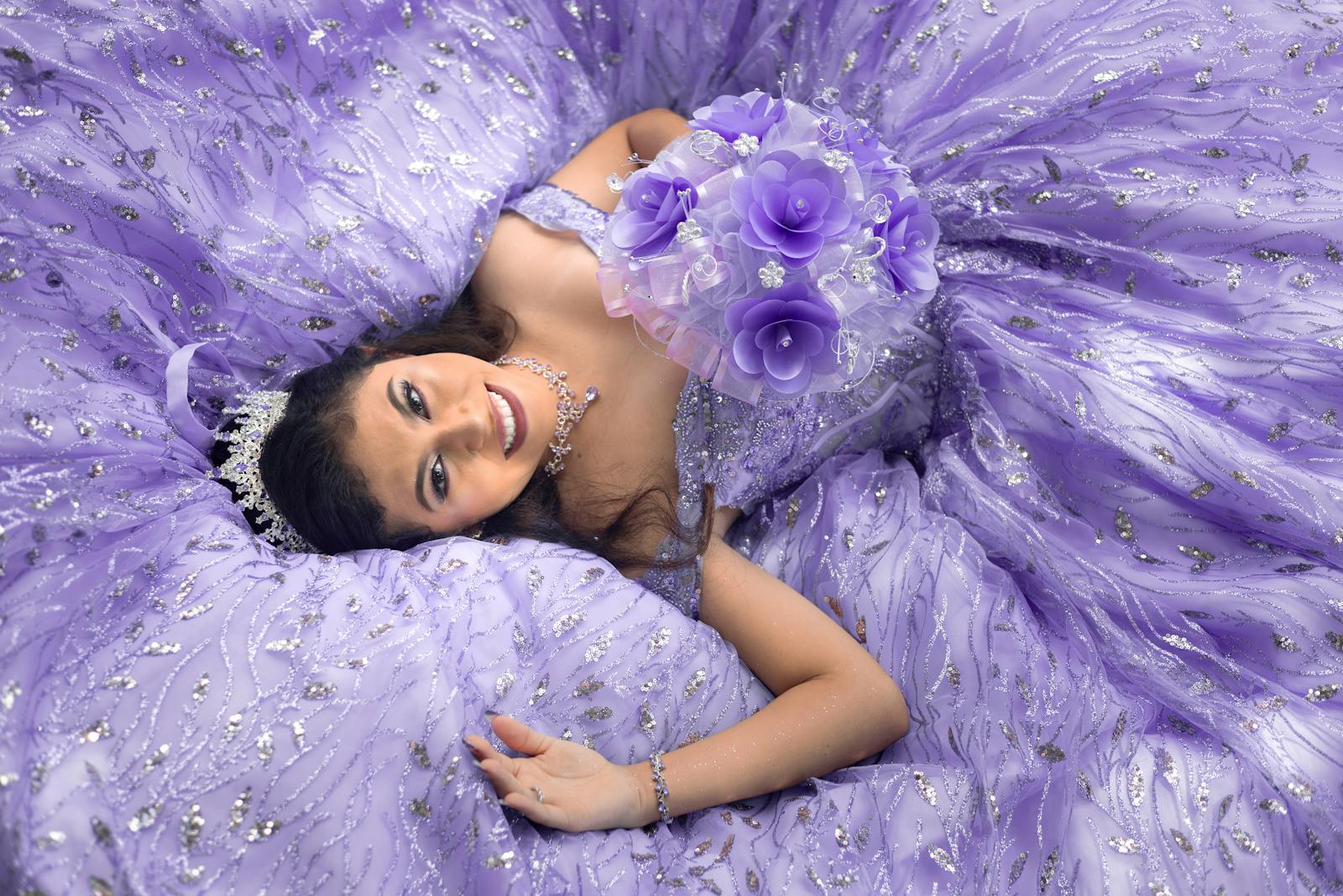 Beautiful quinceañera portrait in a stunning purple dress, captured outdoors.